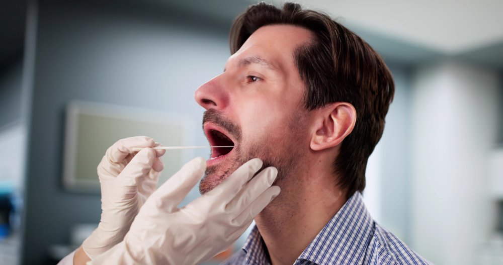 Medical Professional administering mouth swab DNA test for disease identification.